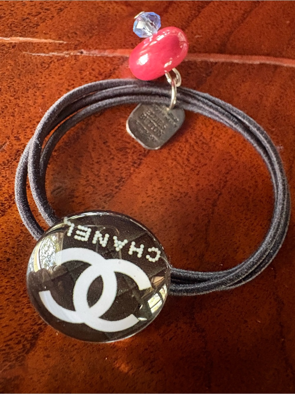 CHANEL Black Hair Tie with White Interlocking CC and Pink Bead